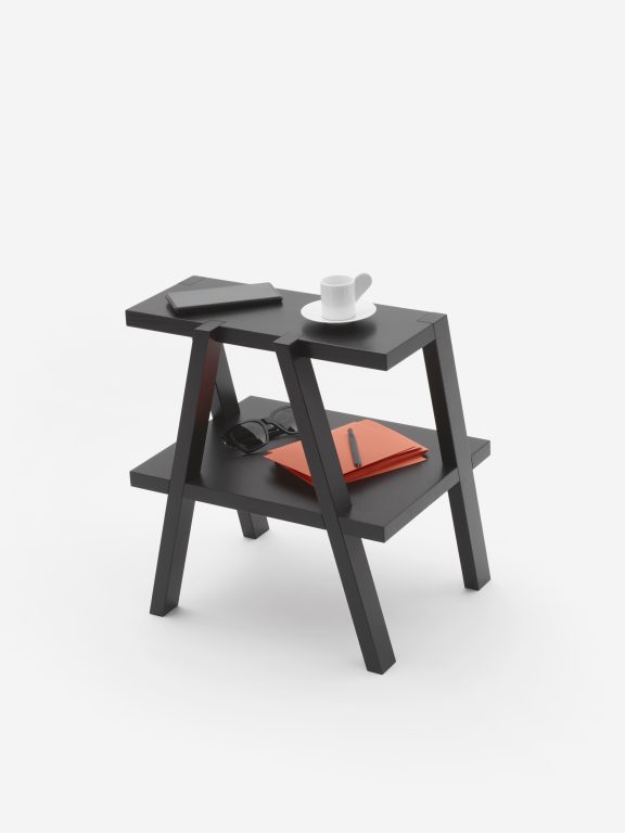 Footstool Aeki in black for Auerberg designed by Relvãokellermann with accessories on top