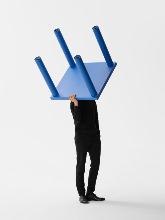 Gumpo pipo table in blue carried by person on shoulder.