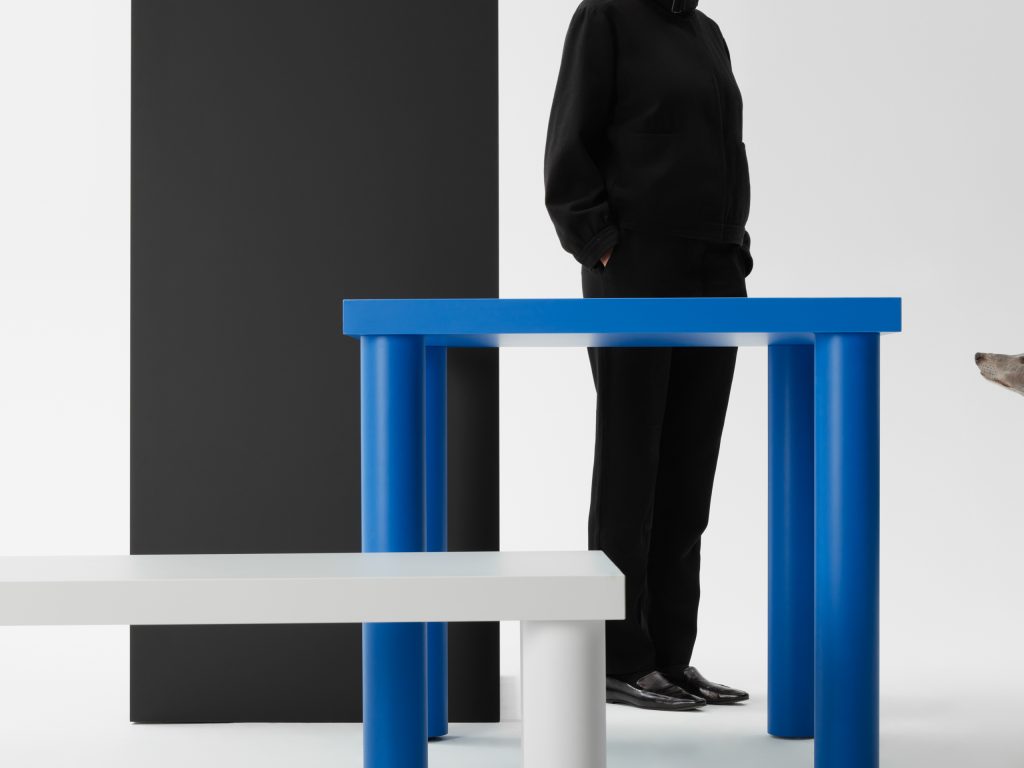 Group image of Gumpo pipo tables in blue, grey and black with person.