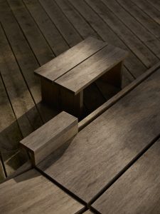 Detail of aged oak sunbed and small oak side table during sundowner. Foeppl Collection by Relvaokellermann for Holzrausch Editions.